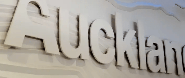 acrylic wall sign displaying the word Auckland in raised letters on a textured background