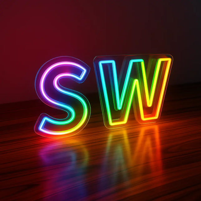 RGB LED neon signs letters SW glowing in vibrant rainbow colors, displayed on a wooden surface with reflections against a dark background